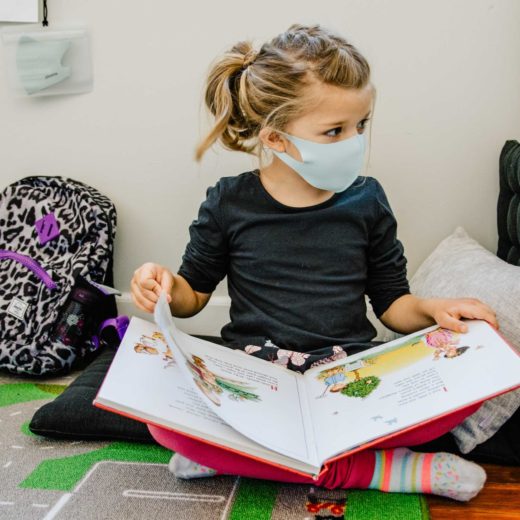 Little girl reading a book.